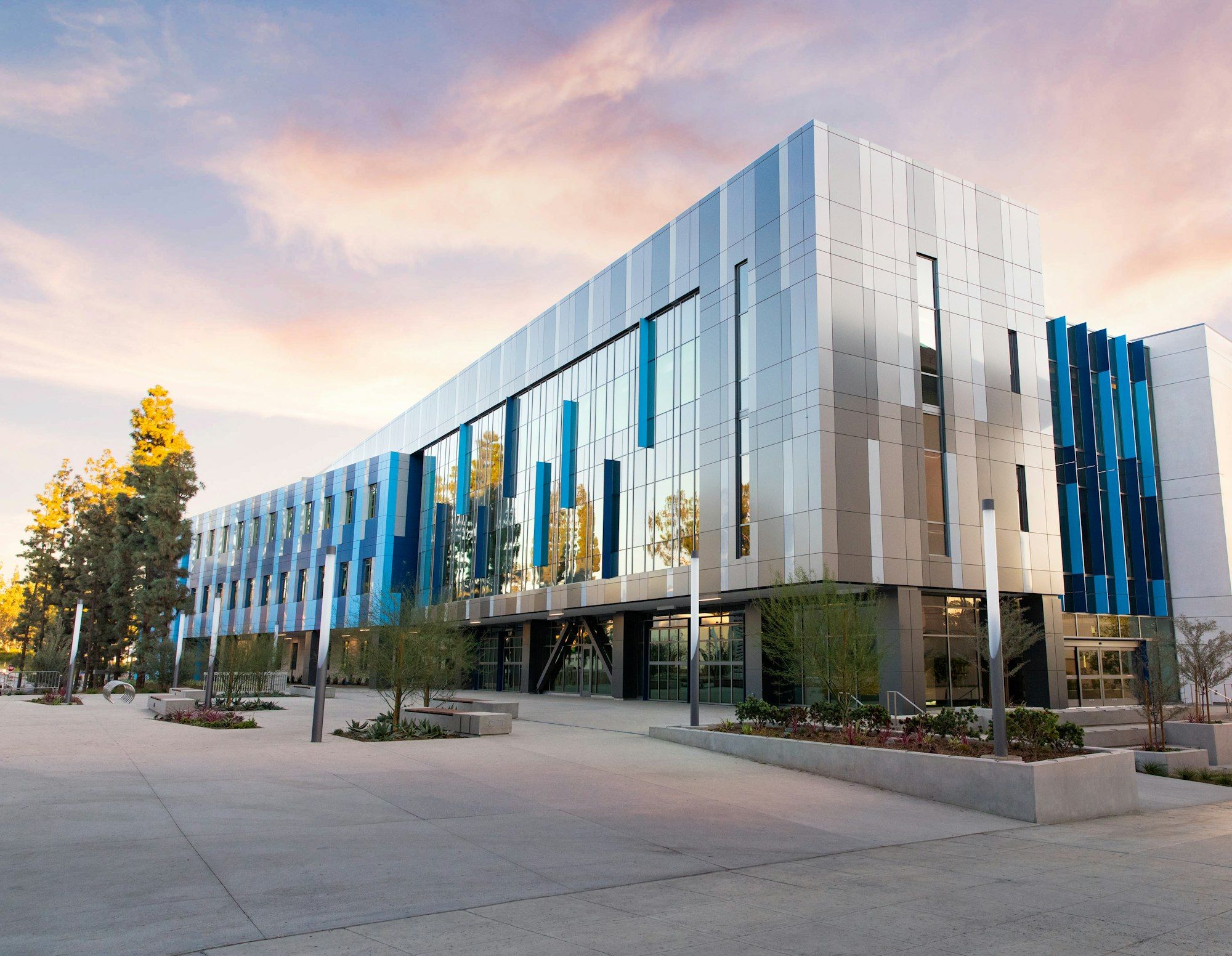 Modern three-story commercial office building with a metal and glass facade