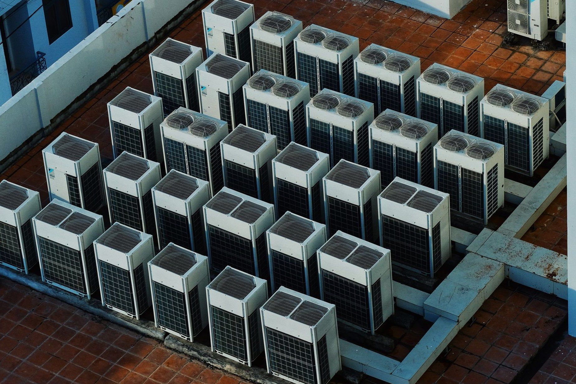 Rows of condensing units on a commercial building rooftop